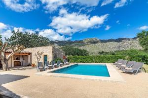 a swimming pool with lounge chairs and a house at Villa Prital by Sealand Villas in Pollença