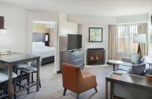 a hotel room with a bed and a living room at Sonesta ES Suites Raleigh Durham Airport Morrisville in Morrisville