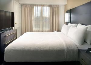 a hotel room with a large bed and a television at Sonesta ES Suites Raleigh Durham Airport Morrisville in Morrisville +21 photos