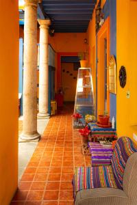 a hallway with columns and a staircase in a house at Hostal Café Tiana in Latacunga