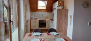a small kitchen with a table with two chairs and a kitchen with at Haus Johanna in Oberberging