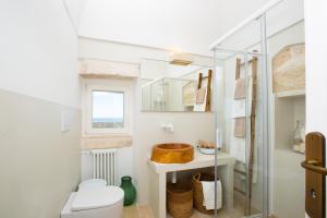 a bathroom with a toilet and a sink at BELLE HOME OSTUNI vasca vista mare in Ostuni