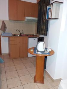 a small kitchen with a table with a microwave at Eftihia studios in Lentas