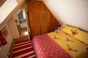 a small bedroom with a bed in a attic at The Wee Cottage in Drumnadrochit