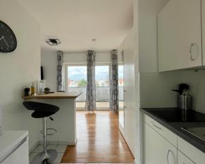 a kitchen with a counter and a window with a view at Studios in Osnabrück - Iburger Str. I home2share in Osnabrück