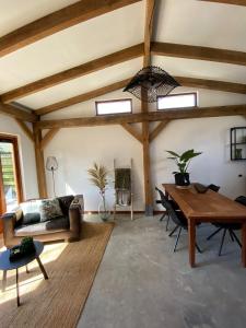 a living room with a couch and a table at Zantverde in Zandvoort