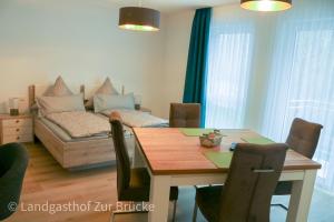 a dining room with a table and a couch at Aparthotel Layblick in Senhals