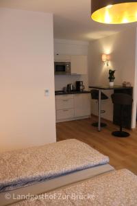 a living room and kitchen with a bed and a table at Aparthotel Layblick in Senhals