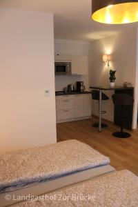 a living room and kitchen with a bed and a table at Aparthotel Layblick in Senhals +36 photos