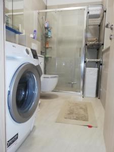a washing machine in a bathroom with a shower at FRANTA in Cres