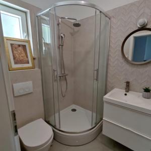 a bathroom with a shower and a toilet and a sink at Nika in Postira