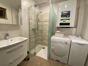 a bathroom with a washing machine and a sink at Ferienhaus Uferweg in Otterndorf +34 photos