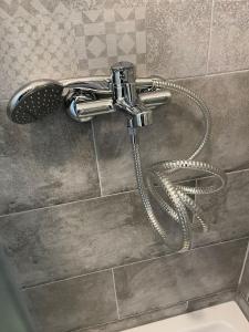 a shower faucet with a hose in a bathroom at Center of Plitvice + Free Parking + Self Check-in in Plitvička Jezera