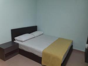 Postel nebo postele na pokoji v ubytování Hotel Permai Melaka Raya