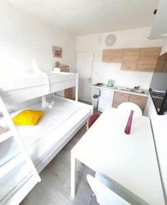 a white room with two bunk beds and a kitchen at Center of Plitvice + Free Parking + Self Check-in in Plitvička Jezera