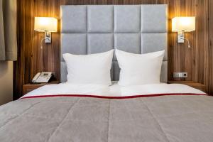 Postel nebo postele na pokoji v ubytování Rathener Hof by STEIGER Hotels