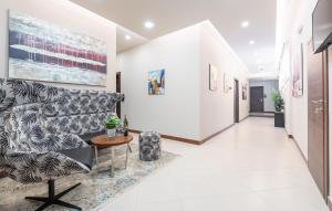 a hallway with a couch and a table at Hotel Dua Residence in Poreč