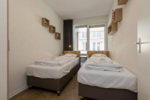 Säng eller sängar i ett rum på Luxury 4 person apartment pet allowed Zoutelande