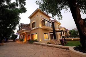 a large house with a driveway in front of it at Della Resorts in Lonavala