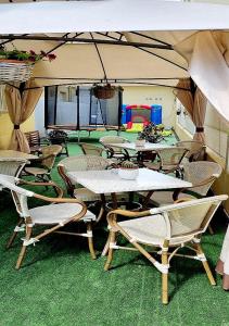 un groupe de tables et de chaises sous une tente dans l'établissement Hotel Brotas, à Rimini