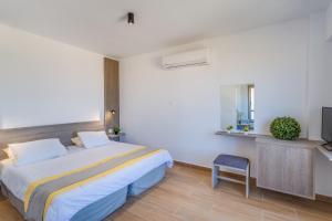 a hotel room with a bed and a television at Toxotis Hotel in Protaras