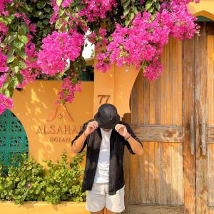 a man wearing a hat and a black jacket at Alsahar Hoi An Boutique Villa in Hoi An