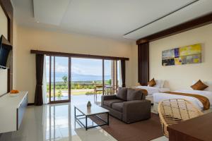 a hotel room with two beds and a living room at Semabu Hills Hotel Nusa Penida in Nusa Penida