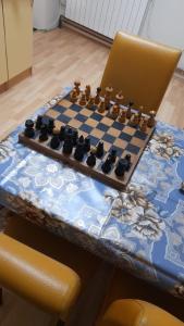 a chess board on a table with a laptop at Zeynep Apartments in Sarajevo