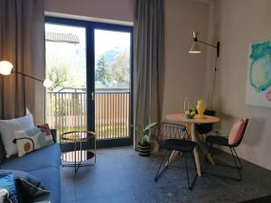 a living room with a blue couch and a table at Picobello Lago in Mandello del Lario