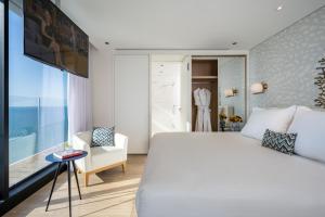 A bed or beds in a room at Vert Lagoon Netanya By AFI Hotels