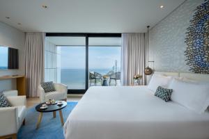 A bed or beds in a room at Vert Lagoon Netanya By AFI Hotels