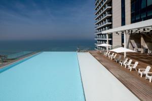 a swimming pool on the side of a building at Vert Lagoon Netanya By AFI Hotels in Netanya
