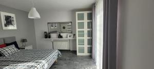 a bedroom with a bed and a mirror at Apartamenty Aquarius - Formoza in Gdynia +24 photos