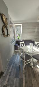 a living room with a table and a couch at Apartamenty Aquarius - Formoza in Gdynia