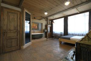 a bedroom with a bed and a bathroom with a tub at Artists Residence in Tbilisi in Tbilisi City
