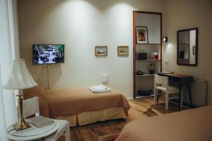 a hotel room with two beds and a desk at Kallithea INN in Platres
