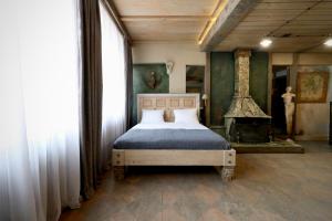 a bedroom with a bed and a fireplace in it at Artists Residence in Tbilisi in Tbilisi City
