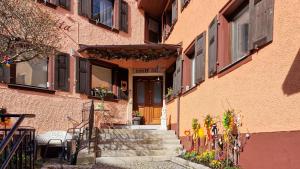 a building with stairs leading up to a door with flowers at Haus Jutta in Gößweinstein