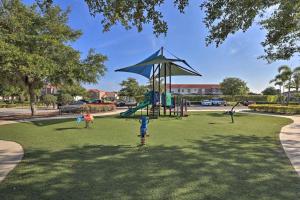 a playground in a park with a swing at Huge 6Br 6Bath Villa & Private pool Min to Disney in Kissimmee
