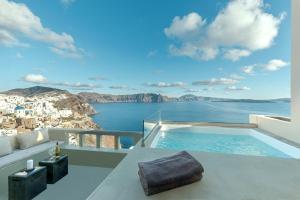 a villa with a plunge pool and a view of the ocean at Caldera Houses Oia in Oia