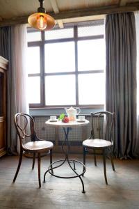 a table and two chairs in front of a window at Artists Residence in Tbilisi in Tbilisi City