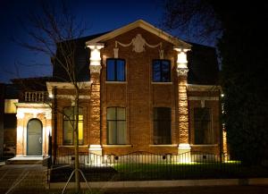 a brick house with lights on it at night at Maison Gand in Ghent