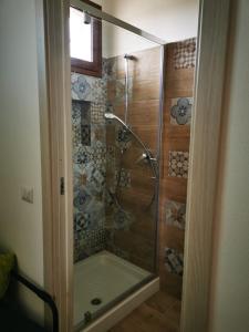 a shower with a glass door in a bathroom at MrBrown - Cinzia Resort Beach in Mazara del Vallo