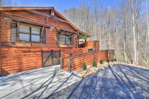 a log house with a driveway in front of it at The Lodge Nantahala River in Bryson City