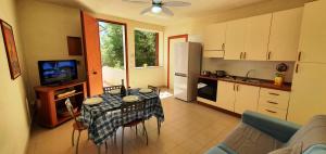 a kitchen with a table with a table cloth on it at Via Ugento Apartments - GiHome in Sant'Isidoro