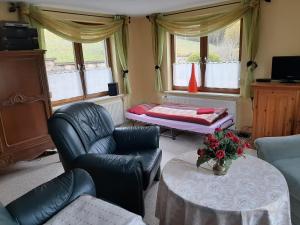 a living room with a couch and a table at Ferienwohnung Sylvia-Marie in Ziegenrück