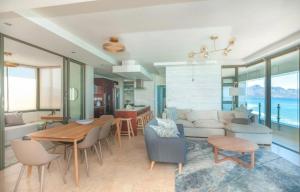 sala de estar con sofá y mesa en Sea and Mountain View Paradise Designer 2 Bedroom Apartment 4 Adults and 2 Kids ONLY - Minimum 3 night stay - in STRAND - With Back-up power!, en Ciudad del Cabo