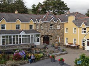 a group of people sitting in front of a building at Dan O'Hara Farmhouse B&B in Clifden