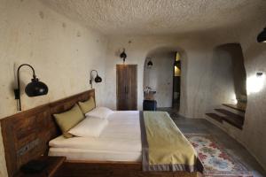a bedroom with a large bed in a room at 1811 Cave Hotel in Nevşehir