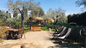 a patio with a bunch of chairs and tables at Butterfly House Bed & Breakfast in Alghero